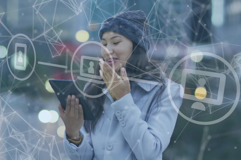 Woman smiling at screen with surrounding graphic of connecting networks.