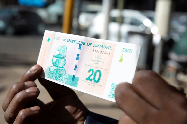 Hands holding a banknote