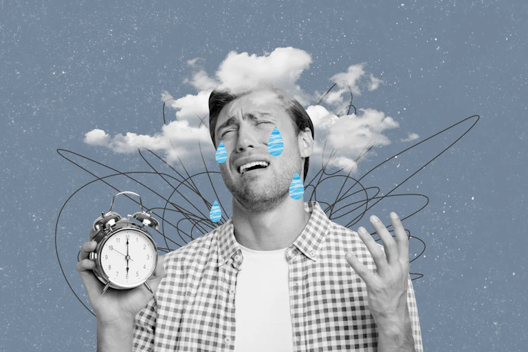 Man holds alarm clock and weeps