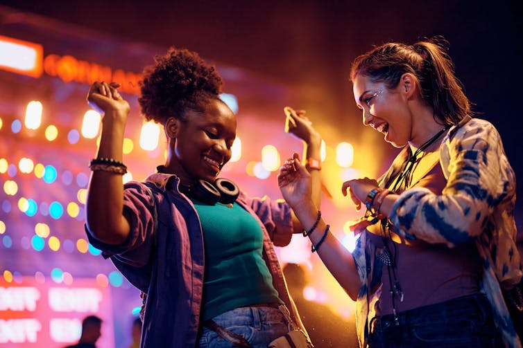 Women dance on a night out.