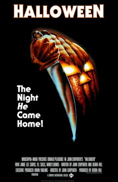 A movie poster from the movie 'Halloween' depicting a hand holding a big kitchen knife.