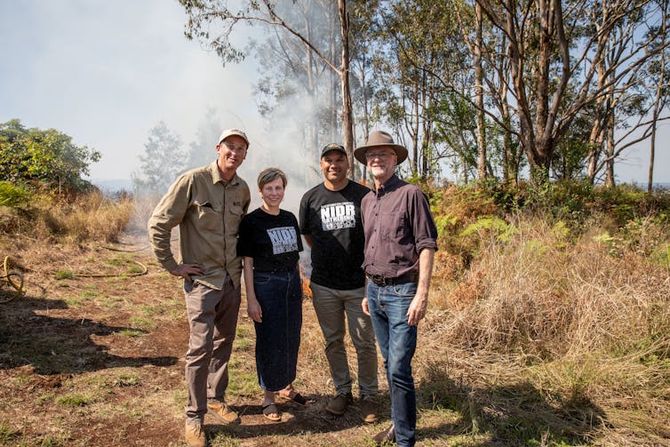people standing in grasslands