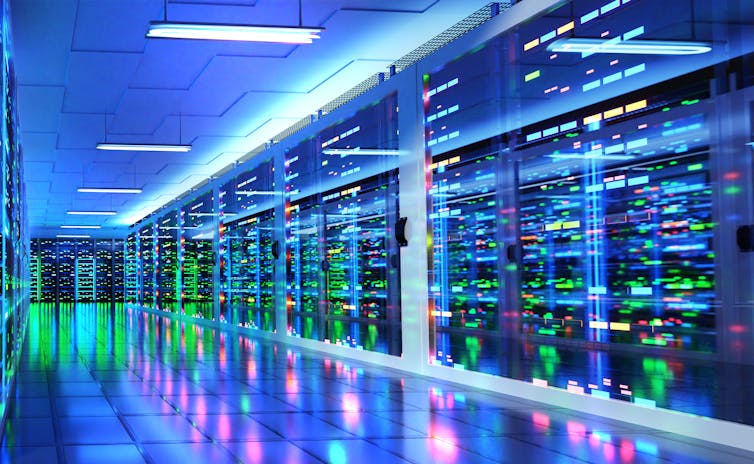 An image of a modern server room and corridor in a data centre with supercomputer racks, neon lights and air conditioners.