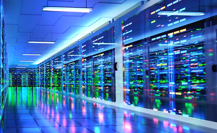 An image of a modern server room and corridor in a data centre with supercomputer racks, neon lights and air conditioners.