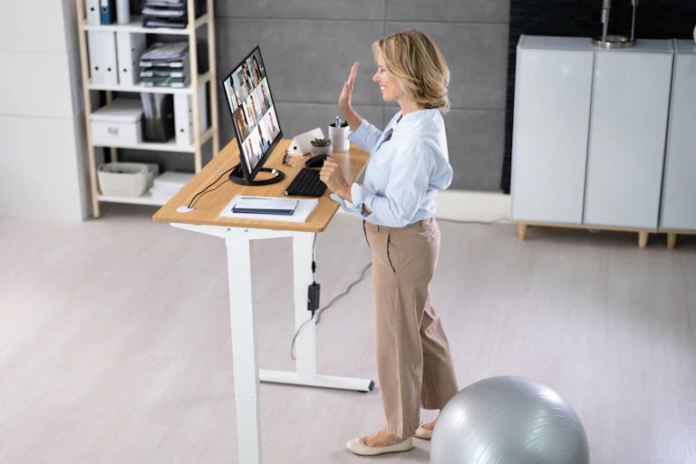 Woman in front of a standing desk.