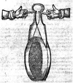 Fingers pointing to a pair of shears