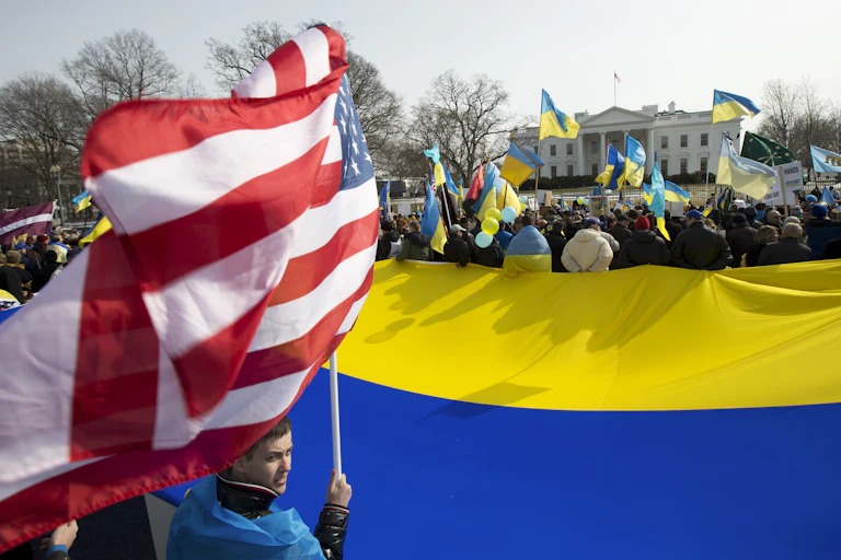 Ukrainian flags are waved by supporters outside the White House.