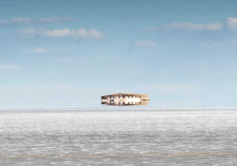 An atmospheric quirk shows a building appearing to float above the land.