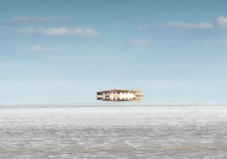 An atmospheric quirk shows a building appearing to float above the land.