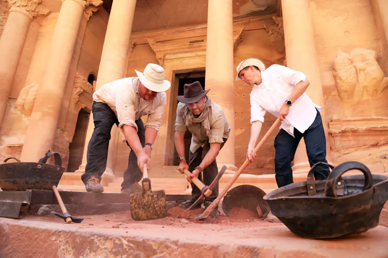 three men digging