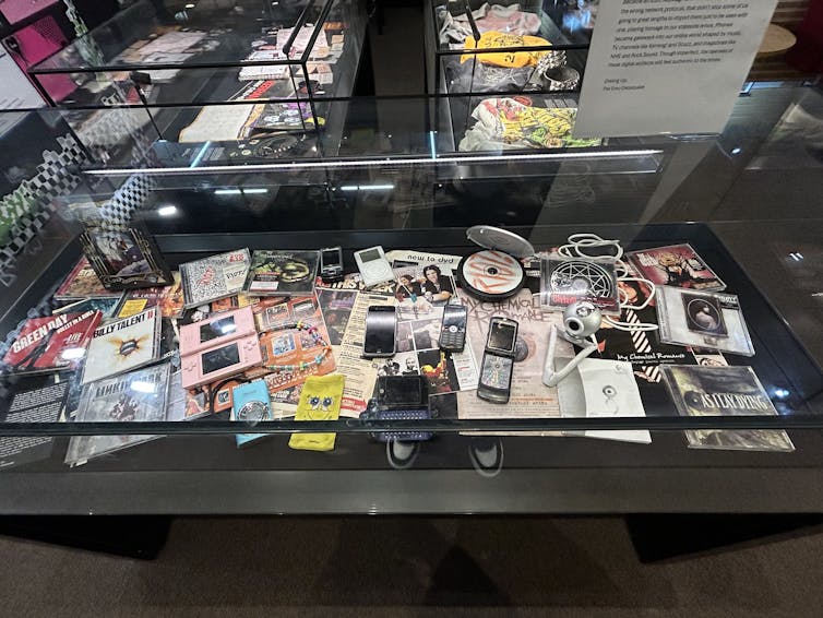 Cabinet full of emo items including ipods and CDs