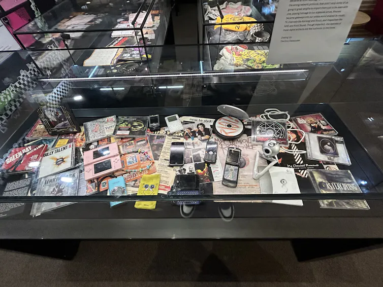 Cabinet full of emo items including ipods and CDs