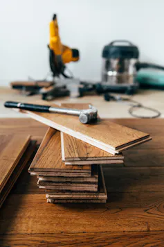 stack of new floorboards with a hammer on top
