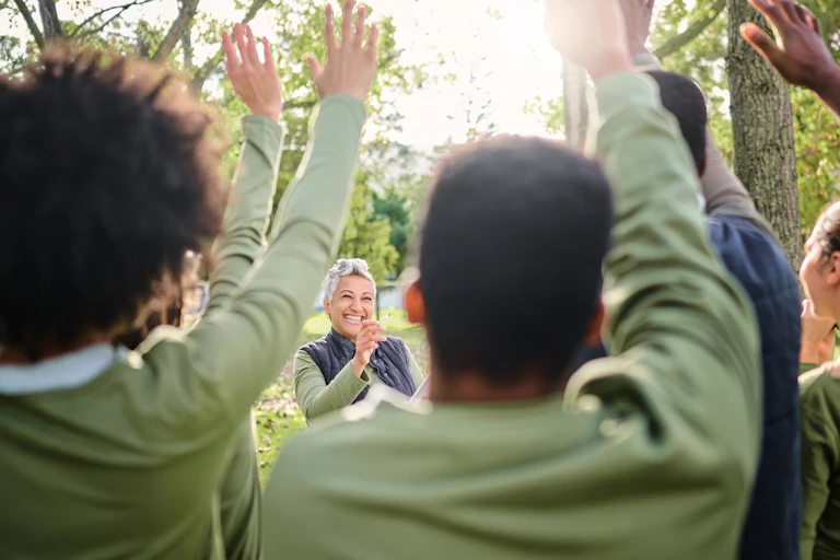 Woman smiling surrounded by people.