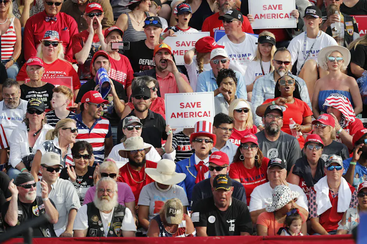 Supporters of Donald Triump hold up signs saying 'Save America' at a rally in Ohio, 2021.