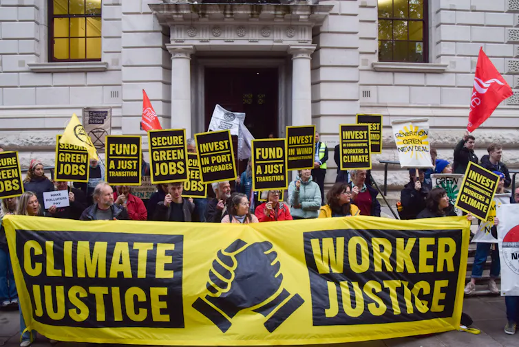Protesters behind 'climate justice = worker justice' banner