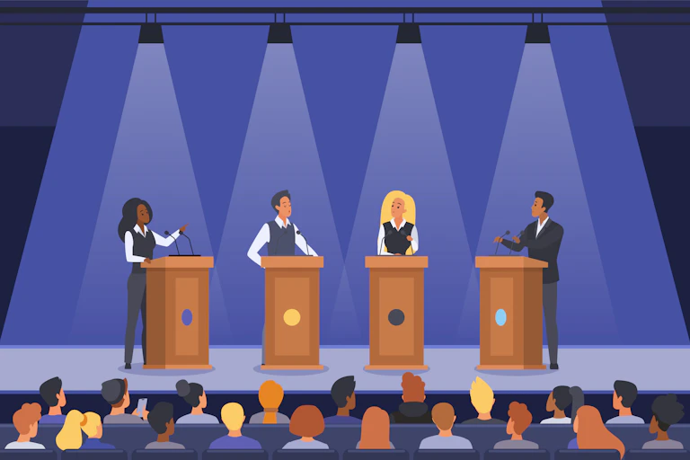 Two women and two men at lecterns on a stage above an audience.
