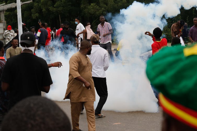 Police and soldiers intervene with tear gas to disperse the crowd gathered at Eagle Square, protesting against the rising cost of living following the removal of gasoline subsidies in Abuja,