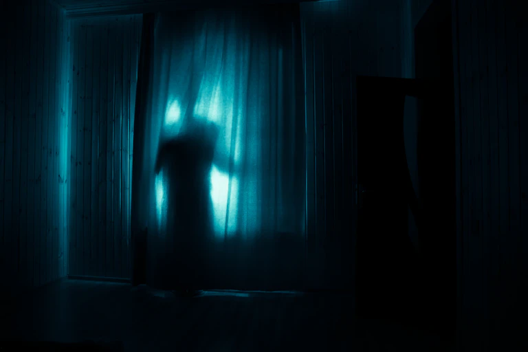 creepy shadow behind a curtain