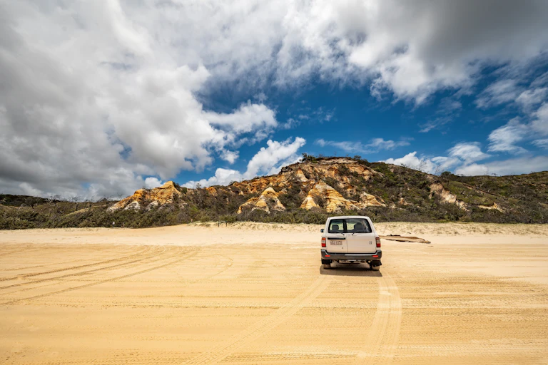A ute on a deserted beach.