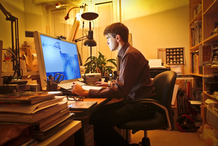 Man studying at computer late at night