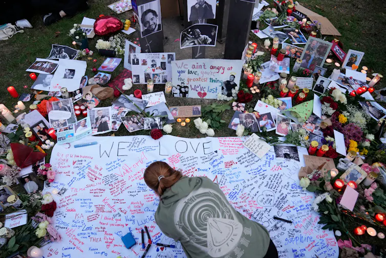 candles, photos and messages in a vigil for Payne.
