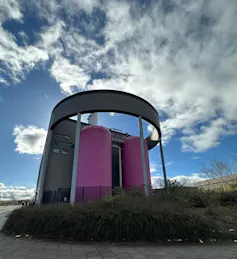 huge pink factory containers holding mine water