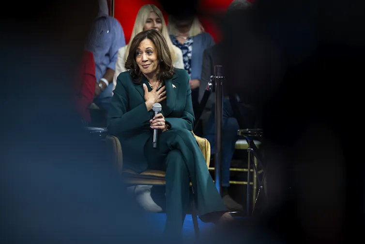 Kamala Harris during an interview with her hand on her chest.