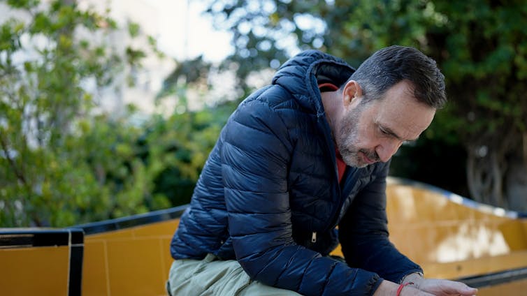 Pensive man sitting outdoors