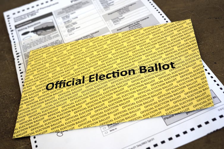 A yellow rectangle with printing on it that says 'Official Election Ballot.'