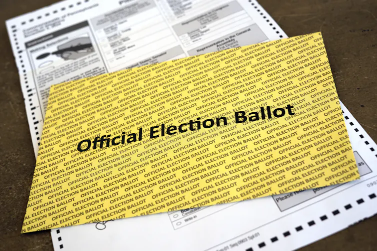 A yellow rectangle with printing on it that says 'Official Election Ballot.'