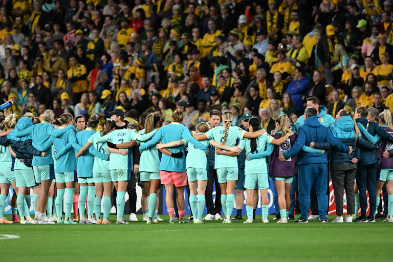 The Matildas link arms after a loss in the 2023 women's World Cup