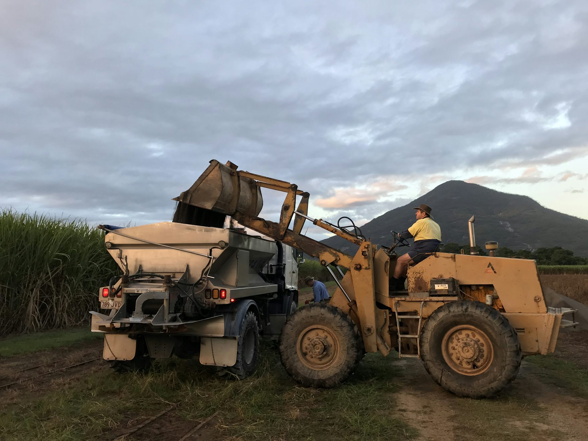 Loading crushed basalt into a spreader for application to trial plots on a sugarcane farm in North Queensland