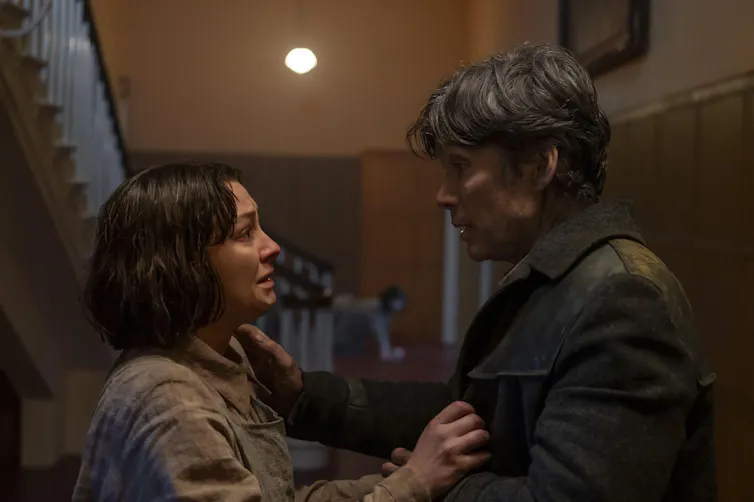 Cillian Murphy and Zara Devin looking at each other, shocked