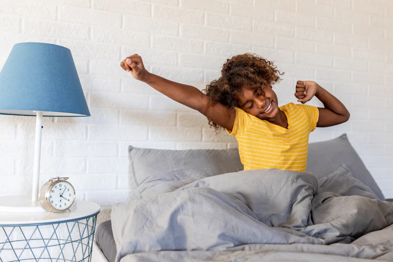 Smiling girl waking up in the morning.