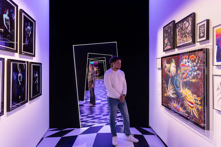 People look at the art on show at the exhibition.