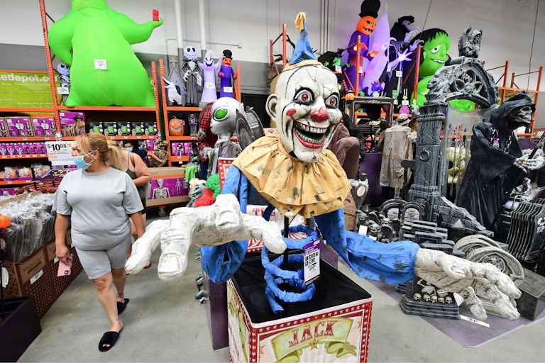 A six-foot-tall evil-clown jack-in-the-box is seen in the Halloween supplies aisle of a Home Depot.