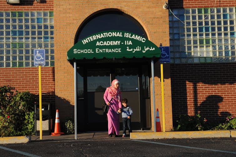 A woman and her son leaving an Islamic cultural center