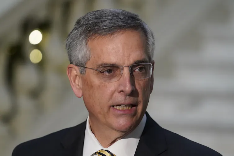 A man with grey hair in a suit