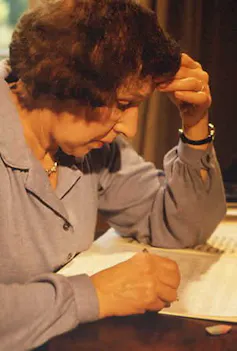 A woman writing music.
