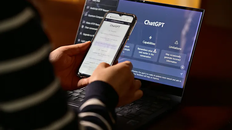A pair of hands holding a phone with Chat GPT loaded up.