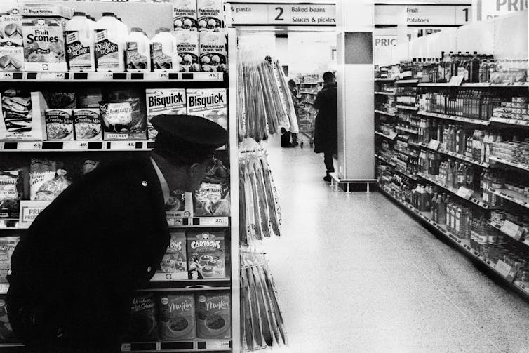 A security guard watching a shoplifter.