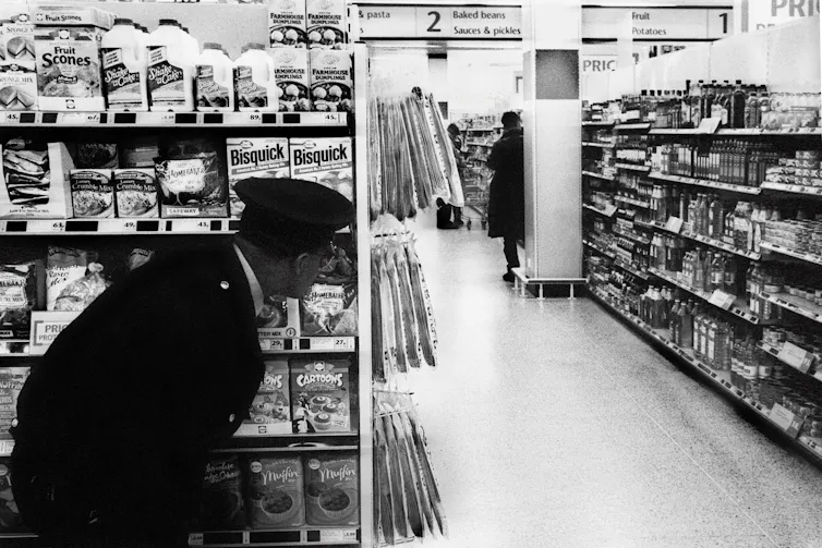 A security guard watching a shoplifter.