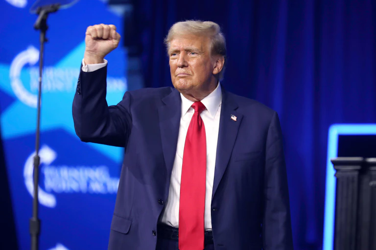 Donald Trump with his arm raised.