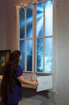 woman opening drawers under a large false window