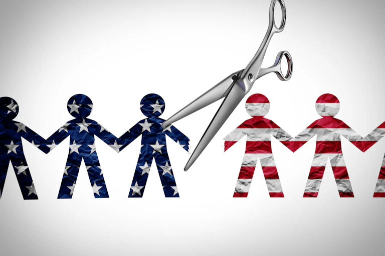 Paper dolls, half blue with white stars and half red and white striped, divided by a scissors in a conceptual design.