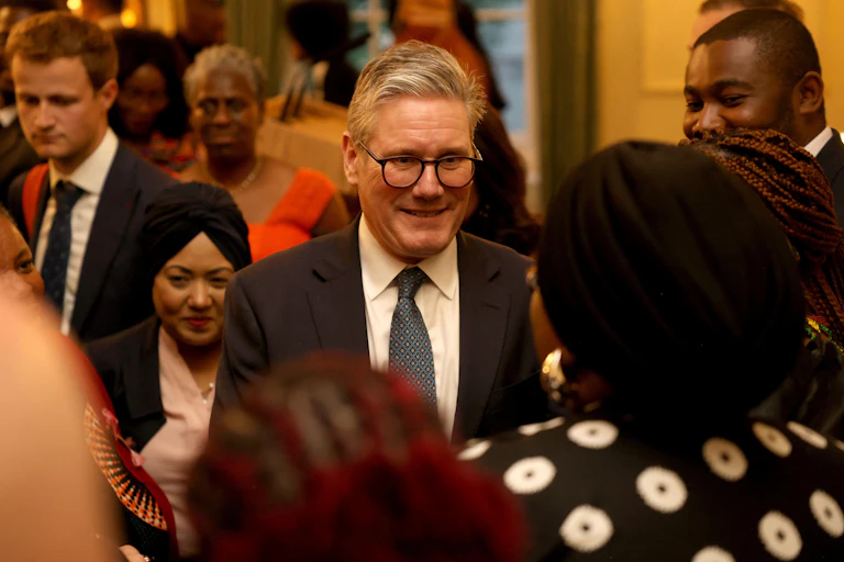 Keir Starmer talking to guests at a black history month event.