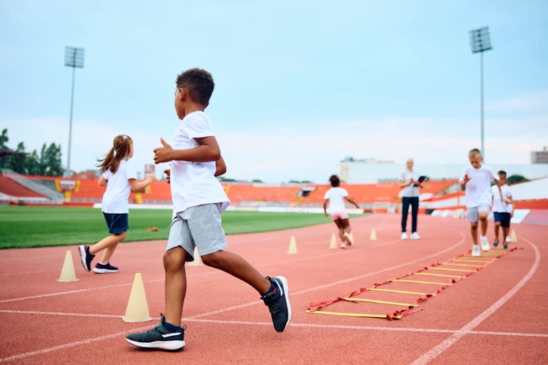 Children enjoy running games at an athletics track