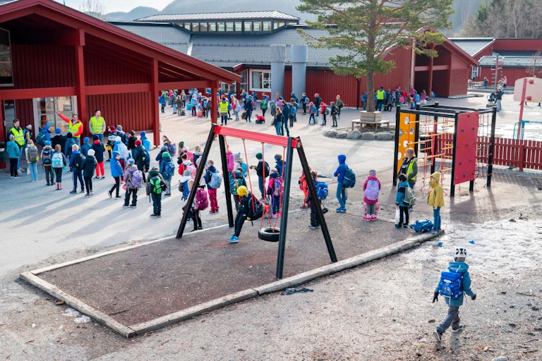 Norwegian school children wait in a playground to go into classrooms.