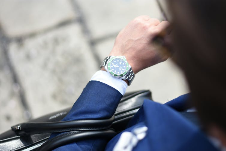 Expensive watch on a man's hand.